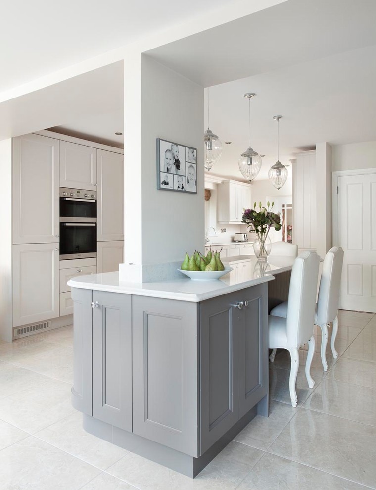 Large traditional u-shaped open plan kitchen in Other with an undermount sink, beaded inset cabinets, grey cabinets, quartzite benchtops, grey splashback, stone slab splashback, stainless steel appliances, porcelain floors, with island and grey floor.