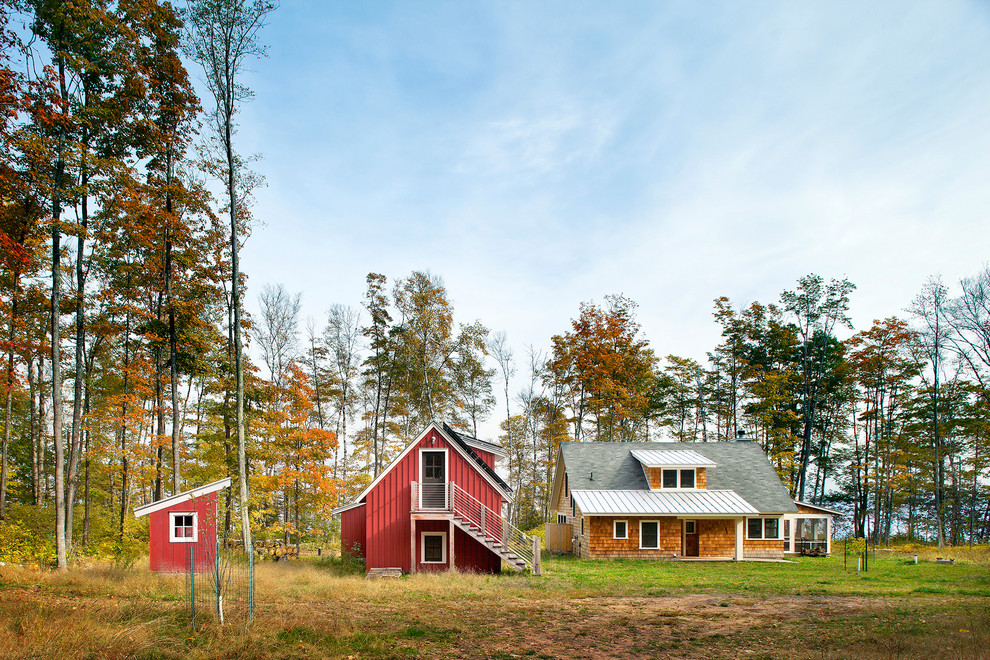 Example of a mid-sized country red two-story wood gable roof design in Minneapolis