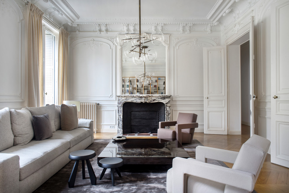Großes Modernes Wohnzimmer mit weißer Wandfarbe, hellem Holzboden, Kamin, Kaminumrandung aus Stein und braunem Boden in Paris