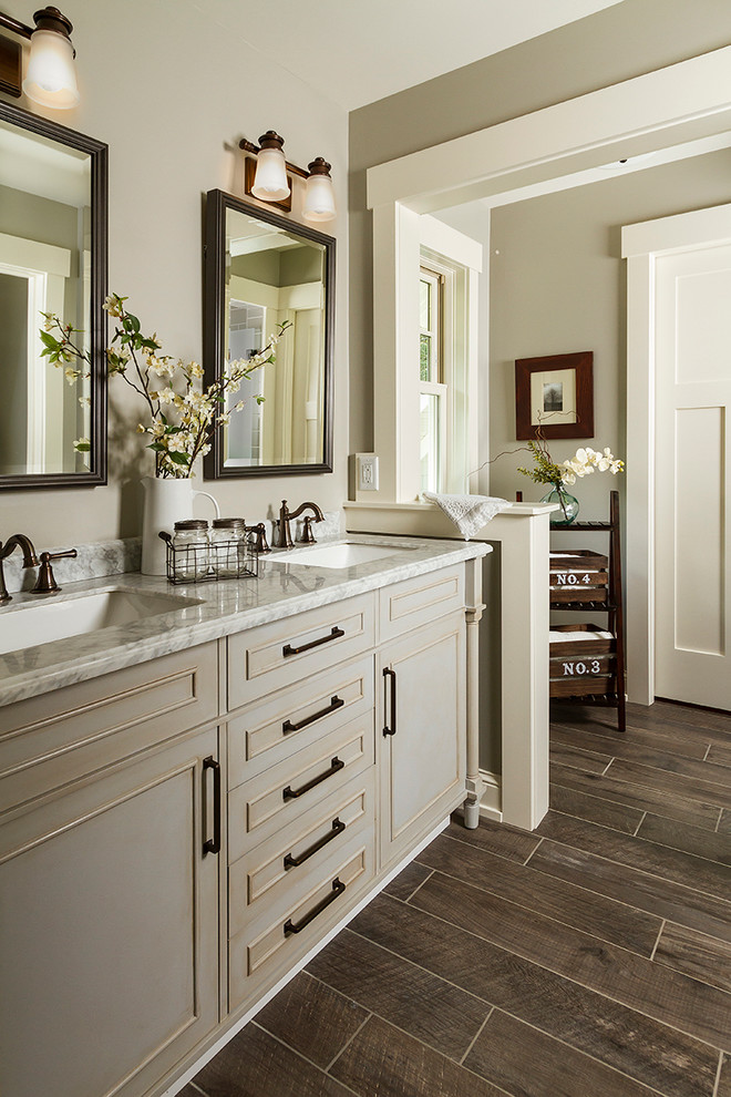 Inspiration for a mid-sized traditional master bathroom in Minneapolis with grey cabinets, a double shower, a two-piece toilet, gray tile, subway tile, white walls, mosaic tile floors, an undermount sink, marble benchtops and recessed-panel cabinets.
