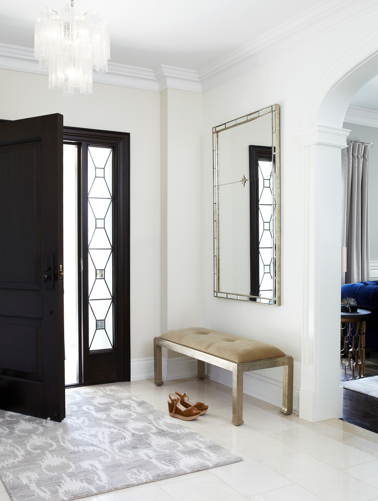 Transitional foyer in Toronto with white walls, a single front door and a black front door.