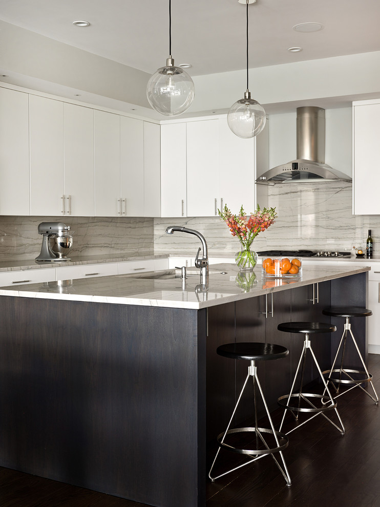 This is an example of a contemporary l-shaped kitchen in Chicago with an undermount sink, flat-panel cabinets, white cabinets, grey splashback, dark hardwood floors and with island.
