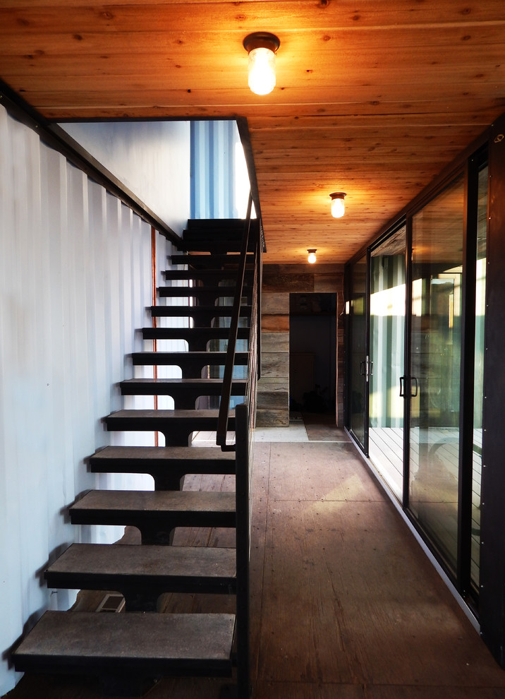 Inspiration for a small industrial concrete straight staircase in Denver with open risers.
