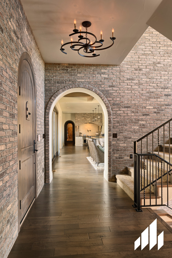 Inspiration for a mid-sized rustic dark wood floor foyer remodel with a dark wood front door
