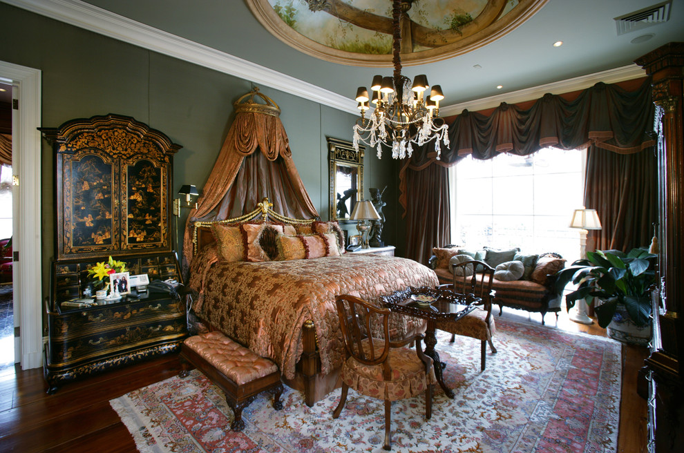 Photo of a mid-sized traditional master bedroom in New Orleans with green walls, medium hardwood floors and no fireplace.