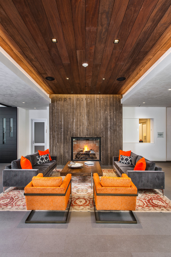 Design ideas for a large contemporary formal open concept living room in Denver with white walls, a standard fireplace, a wood fireplace surround, concrete floors, no tv and grey floor.