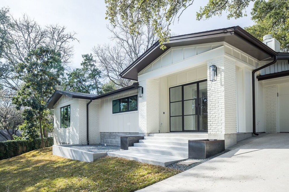 Inspiration for a transitional white one-story brick gable roof remodel in Austin
