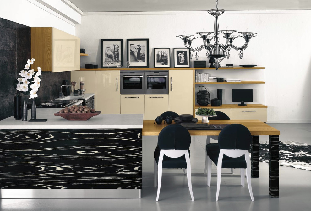 This is an example of a contemporary kitchen in London with flat-panel cabinets, beige cabinets and black splashback.