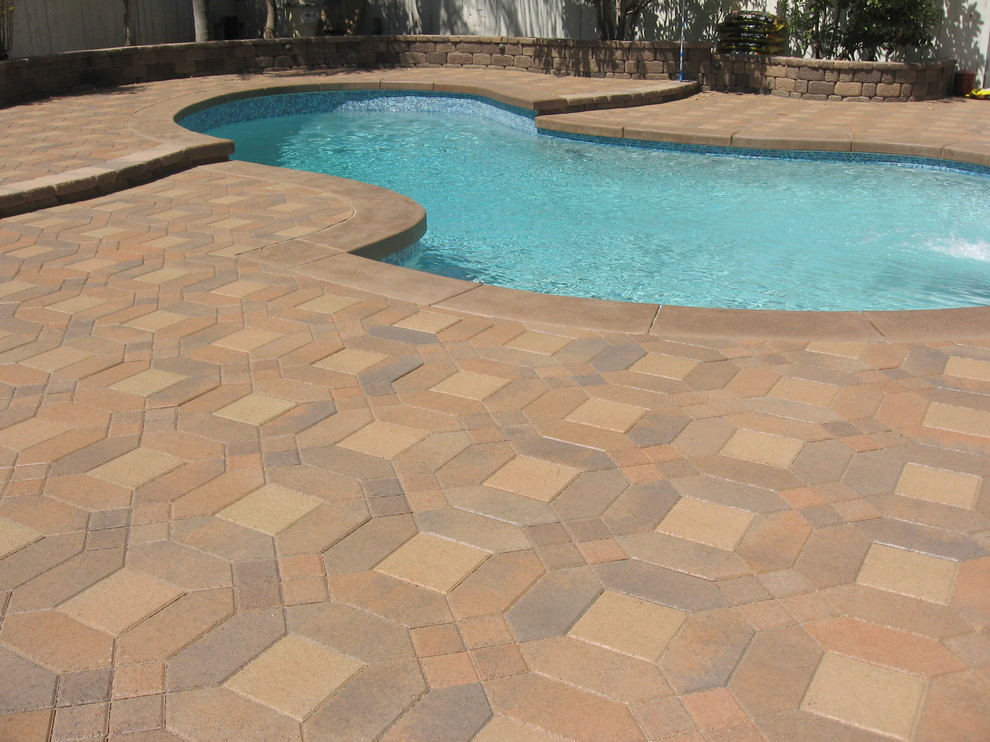 Inspiration for a backyard concrete paver pool remodel in Orange County