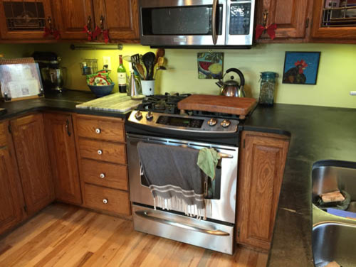 Example of a mid-sized transitional u-shaped kitchen design with raised-panel cabinets, medium tone wood cabinets and a peninsula