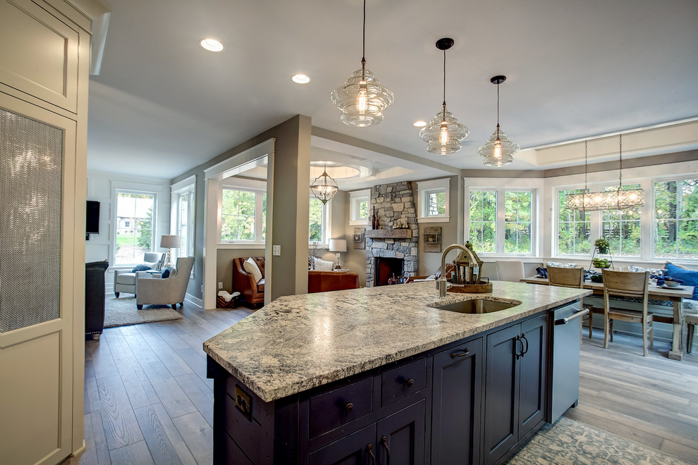 Kitchen - transitional l-shaped kitchen idea in Grand Rapids with an undermount sink, beige cabinets, granite countertops, subway tile backsplash and paneled appliances
