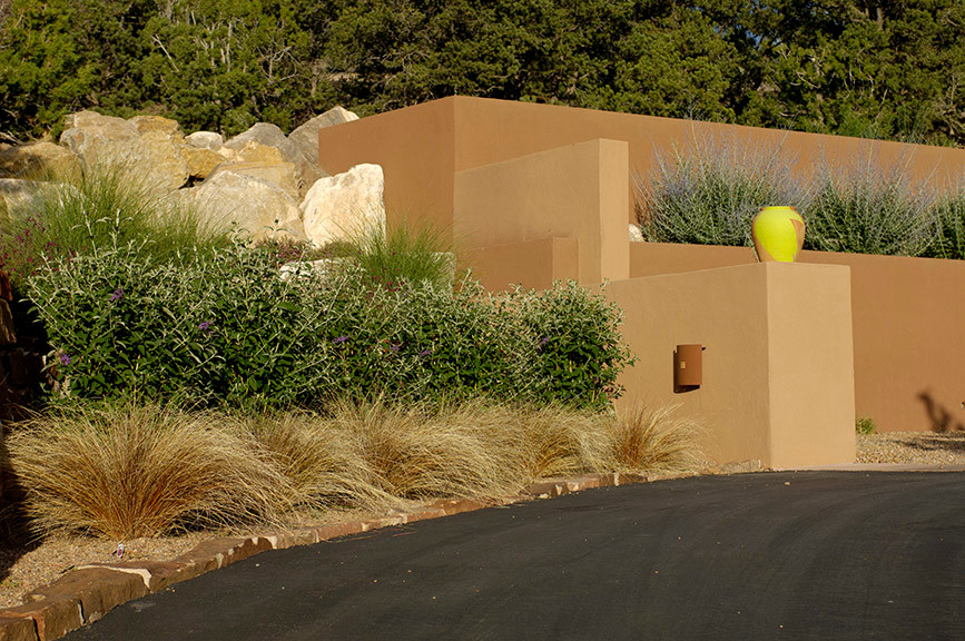 This is an example of a large partial sun front yard concrete paver driveway.