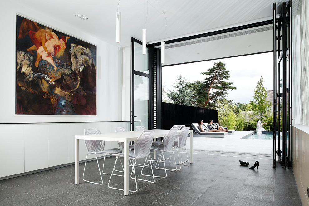 Photo of a mid-sized contemporary separate dining room in Paris with white walls and ceramic floors.