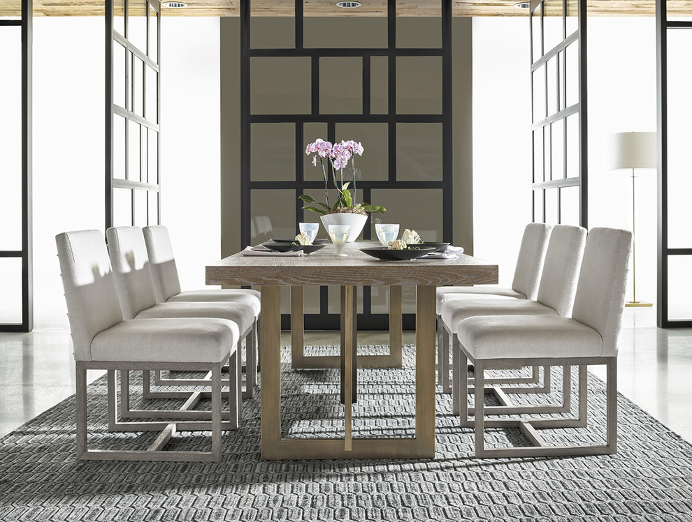 Photo of a modern dining room in Houston with grey walls, concrete floors and grey floor.