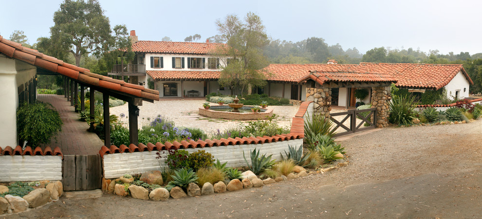 This is an example of a mediterranean two-storey exterior in Santa Barbara with a tile roof.