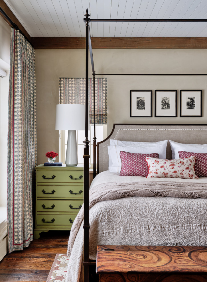 Country bedroom in Burlington with beige walls, dark hardwood floors, brown floor and timber.
