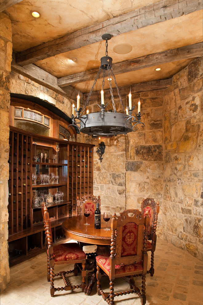 Inspiration for a large traditional wine cellar in Denver with storage racks, terra-cotta floors and beige floor.