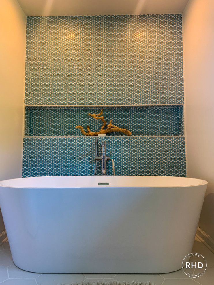 Coastal ensuite bathroom in Atlanta with a freestanding bath, blue tiles and ceramic tiles.
