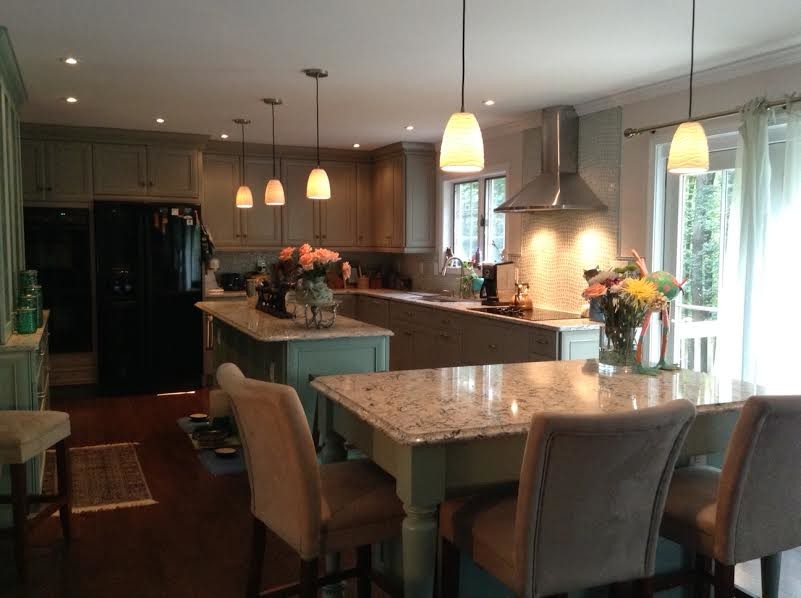 Example of a large transitional l-shaped dark wood floor eat-in kitchen design in Baltimore with a double-bowl sink, recessed-panel cabinets, dark wood cabinets, marble countertops, gray backsplash, glass sheet backsplash, stainless steel appliances and an island