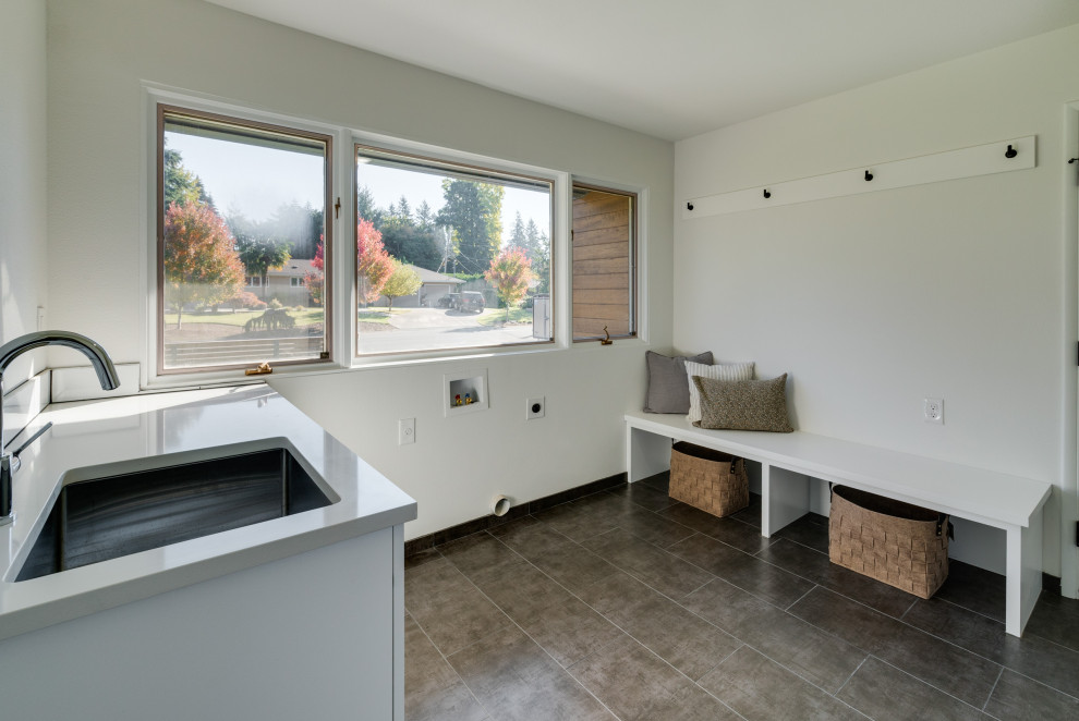 Huge mid-century modern laundry room photo in Portland with a side-by-side washer/dryer