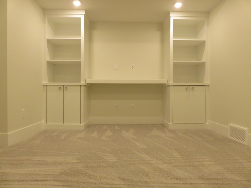 Example of a mid-sized transitional look-out carpeted and gray floor basement design in Calgary with white walls