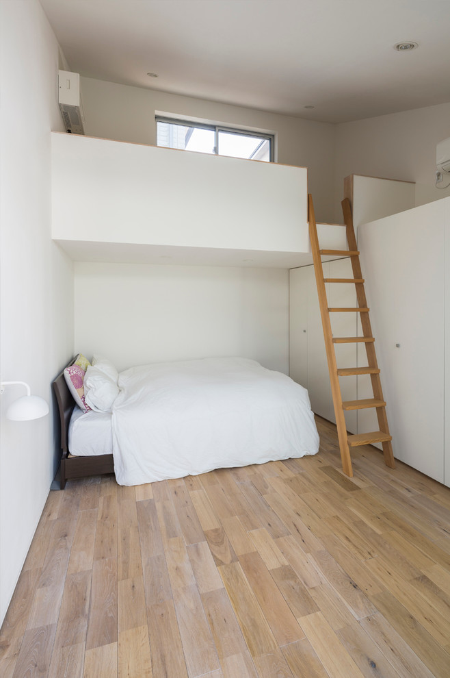 На фото: маленькая спальня в стиле модернизм с белыми стенами, светлым паркетным полом и бежевым полом для на участке и в саду с