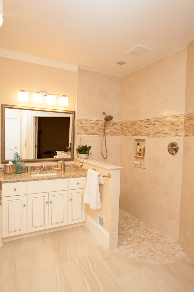 Design ideas for a large transitional bathroom in Other with an undermount sink, raised-panel cabinets, distressed cabinets, quartzite benchtops, a curbless shower, stone slab and pebble tile floors.