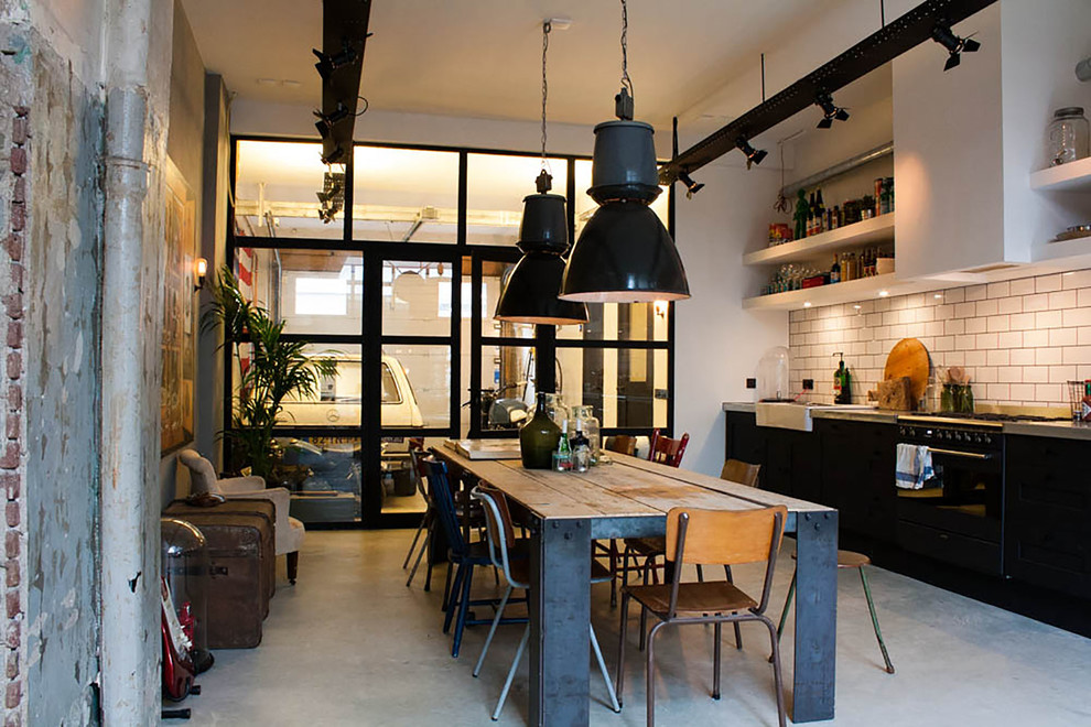 This is an example of an eclectic single-wall eat-in kitchen in Amsterdam with a farmhouse sink, open cabinets, white cabinets, white splashback, subway tile splashback and black appliances.