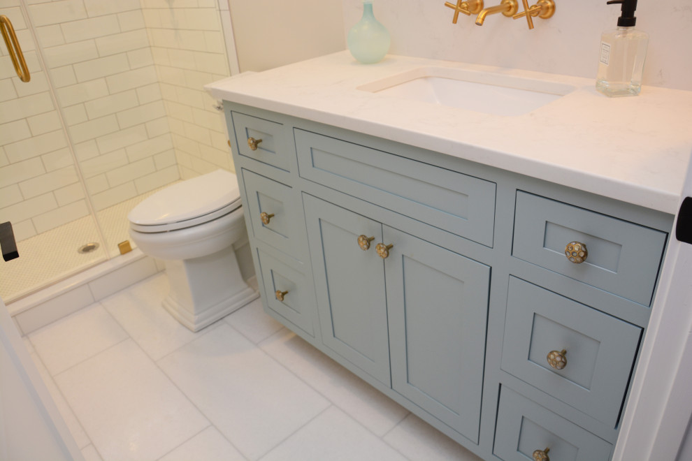 Small transitional kids bathroom in Baltimore with recessed-panel cabinets, blue cabinets, white tile, white walls, an undermount sink, engineered quartz benchtops, multi-coloured floor, a hinged shower door, white benchtops, a single vanity and a freestanding vanity.