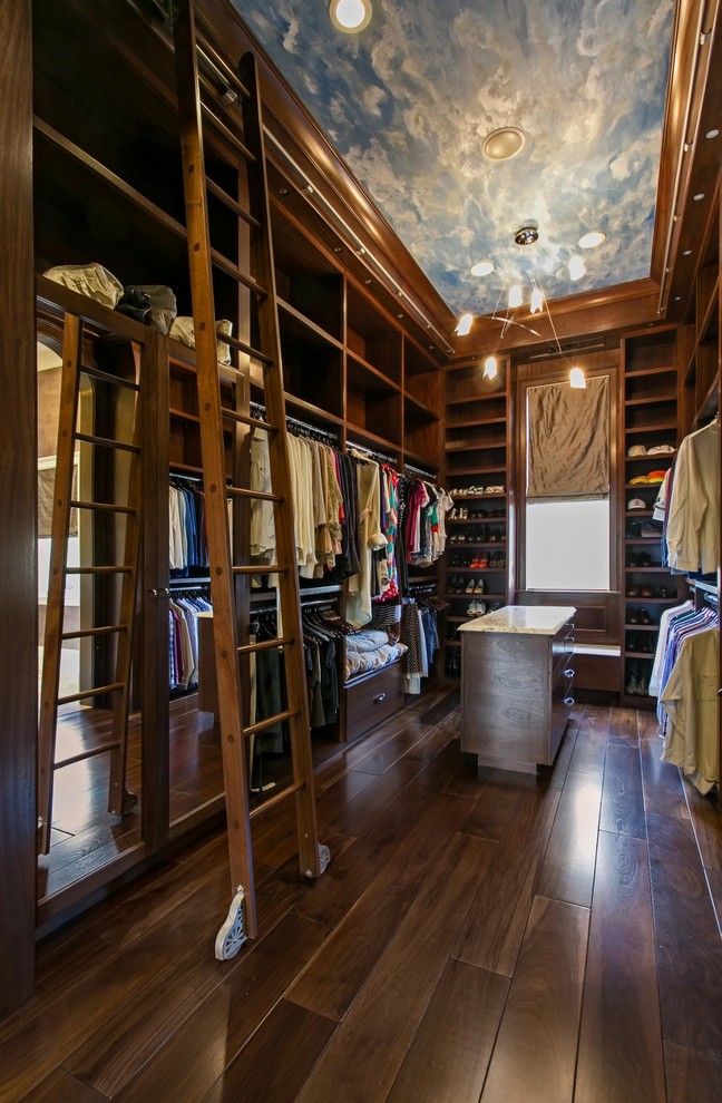 Photo of a traditional men's walk-in wardrobe in Charleston with open cabinets, dark wood cabinets and dark hardwood floors.