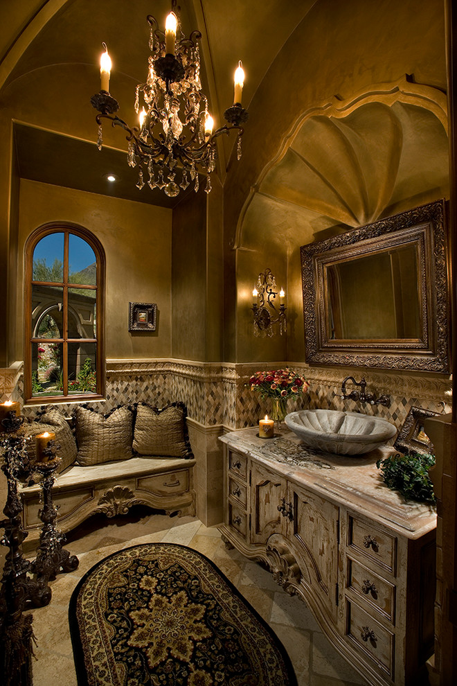 This is an example of an expansive mediterranean powder room in Phoenix with furniture-like cabinets, light wood cabinets, a two-piece toilet, beige tile, mosaic tile, beige walls, travertine floors, a vessel sink and granite benchtops.