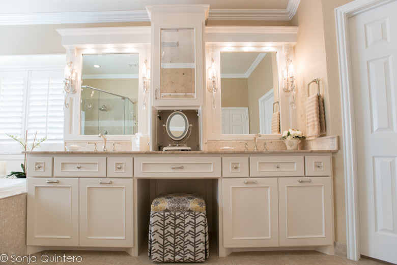 Large transitional master beige tile and stone slab limestone floor drop-in bathtub photo in Dallas with an integrated sink, recessed-panel cabinets, white cabinets, marble countertops, a one-piece toilet and beige walls
