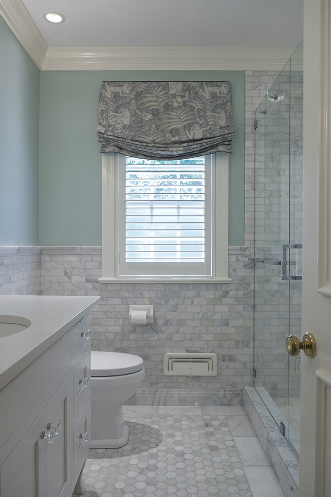 Photo of a mid-sized traditional 3/4 bathroom in Louisville with furniture-like cabinets, white cabinets, an alcove shower, gray tile, stone tile, blue walls, an undermount sink, engineered quartz benchtops and marble floors.