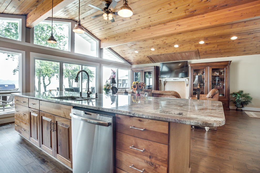 Inspiration for a large rustic kitchen remodel in DC Metro with an undermount sink, raised-panel cabinets, granite countertops, glass tile backsplash, stainless steel appliances and an island