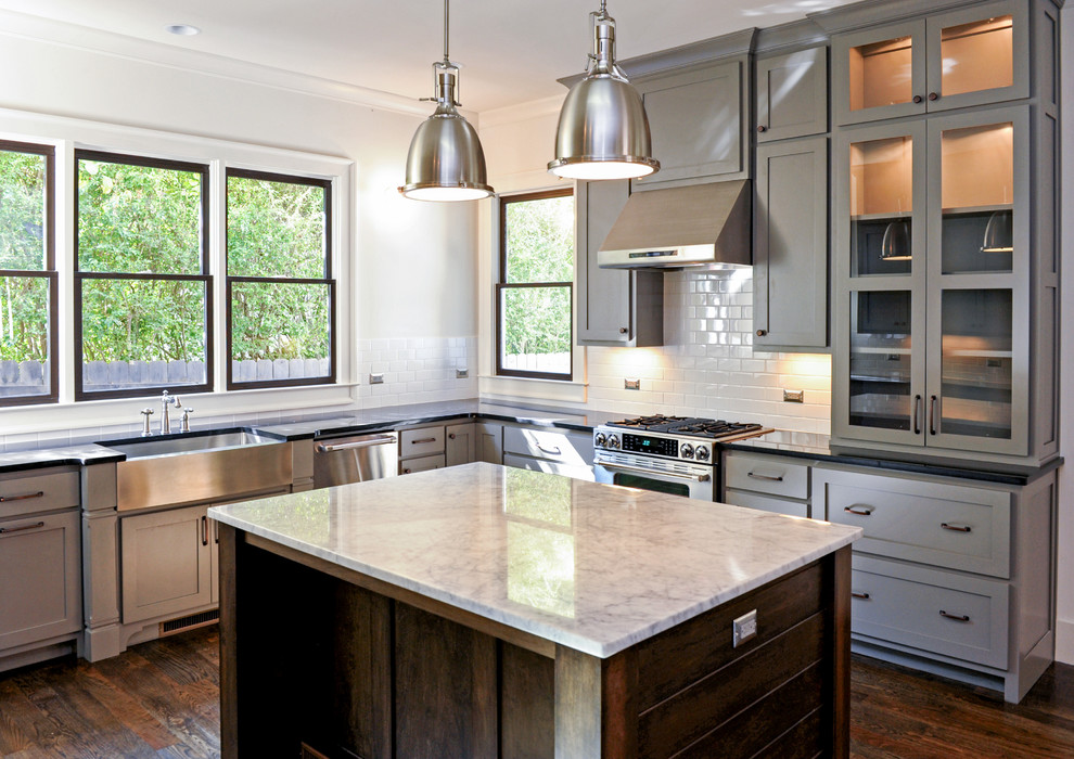Large industrial l-shaped separate kitchen in Atlanta with a farmhouse sink, shaker cabinets, grey cabinets, quartzite benchtops, white splashback, subway tile splashback, stainless steel appliances, dark hardwood floors and with island.