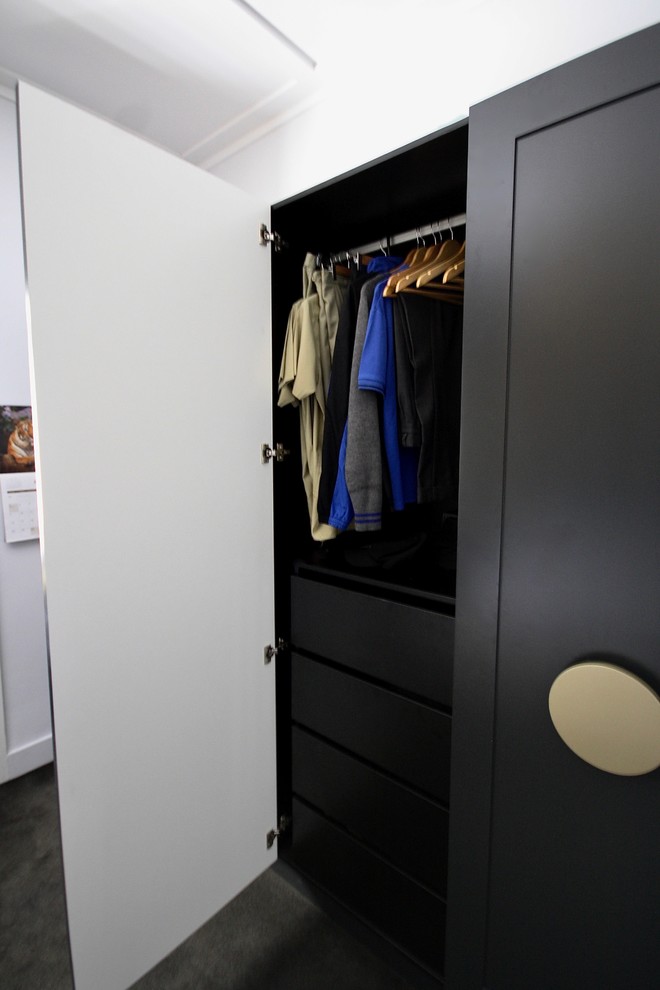 Design ideas for a large transitional gender-neutral built-in wardrobe in Sydney with shaker cabinets, white cabinets, carpet and black floor.