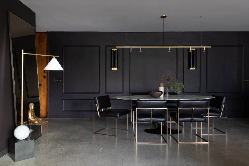 Inspiration pour une salle à manger design avec un mur noir et sol en béton ciré.