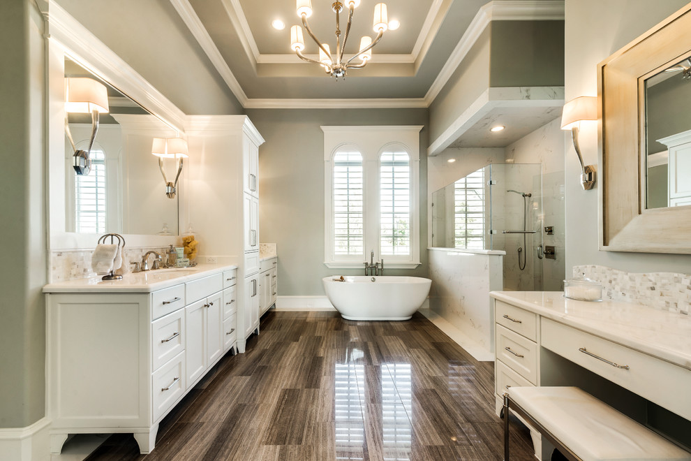 This is an example of a large traditional master bathroom in Dallas with shaker cabinets, white cabinets, engineered quartz benchtops, a freestanding tub, an open shower, green walls, an undermount sink and a hinged shower door.