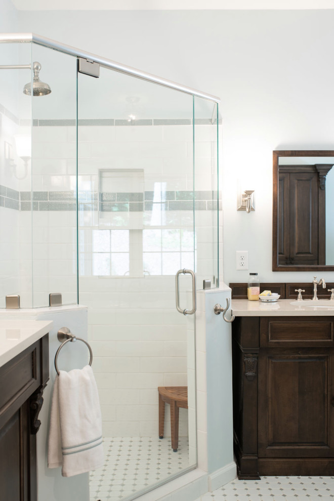 Photo of a large traditional master bathroom in Charlotte with recessed-panel cabinets, dark wood cabinets, a claw-foot tub, a corner shower, a two-piece toilet, white tile, subway tile, blue walls, porcelain floors, an undermount sink, engineered quartz benchtops, multi-coloured floor, a hinged shower door, white benchtops, an enclosed toilet, a single vanity and a freestanding vanity.