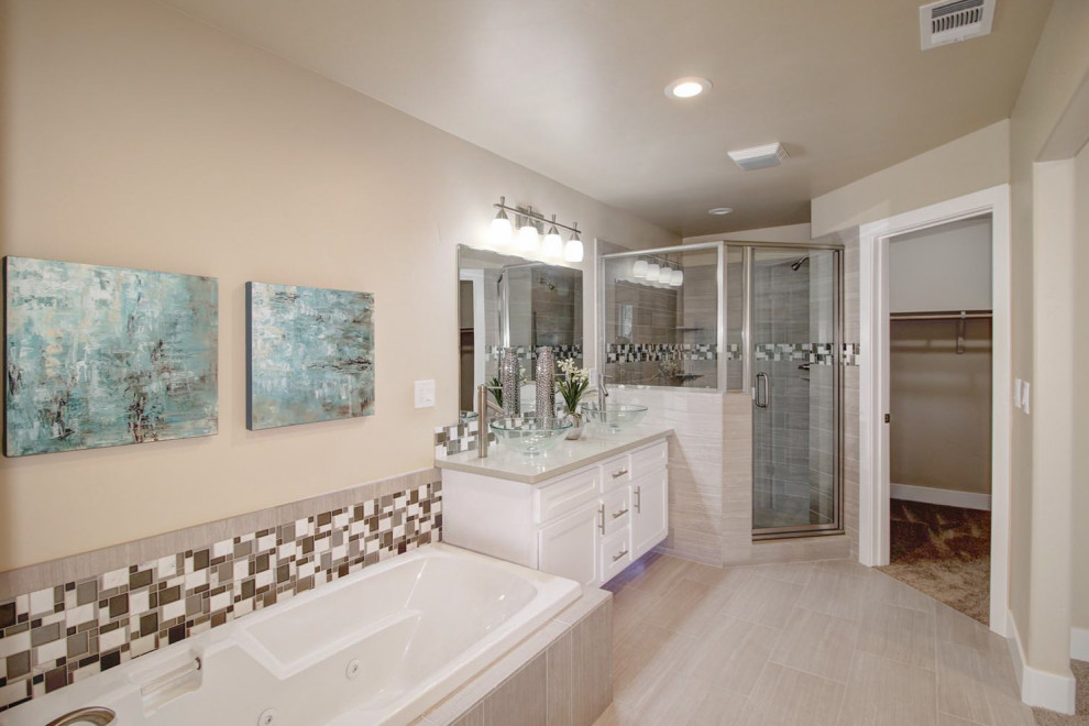 This is an example of a mid-sized modern master bathroom in Sacramento with a hot tub, a corner shower, beige walls, laminate floors, a vessel sink, grey floor, recessed-panel cabinets, white cabinets, a two-piece toilet, multi-coloured tile, mosaic tile, engineered quartz benchtops, a hinged shower door and beige benchtops.