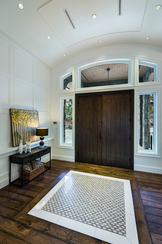 Design ideas for an expansive country foyer in Vancouver with white walls, medium hardwood floors, a double front door, a dark wood front door and brown floor.
