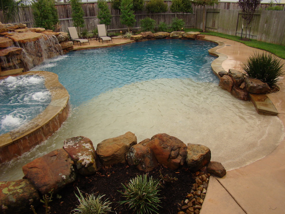 Inspiration for a large traditional backyard custom-shaped pool in Houston with a hot tub and concrete slab.