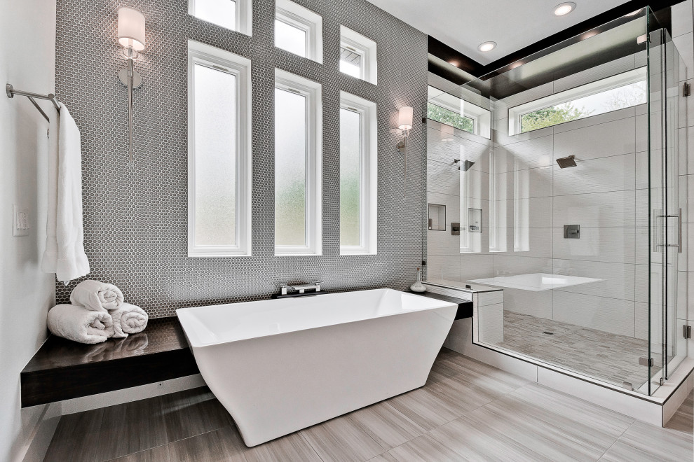 Design ideas for a large modern master bathroom in Other with recessed-panel cabinets, white cabinets, a freestanding tub, a double shower, a one-piece toilet, gray tile, glass tile, white walls, porcelain floors, a trough sink, quartzite benchtops, grey floor, a hinged shower door, white benchtops, a shower seat, a double vanity, a floating vanity and wood walls.