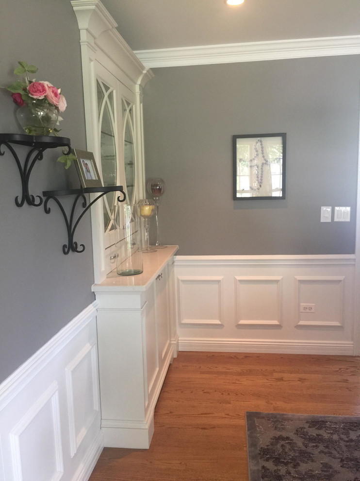 Inspiration for a large transitional medium tone wood floor and brown floor hallway remodel in Chicago with gray walls