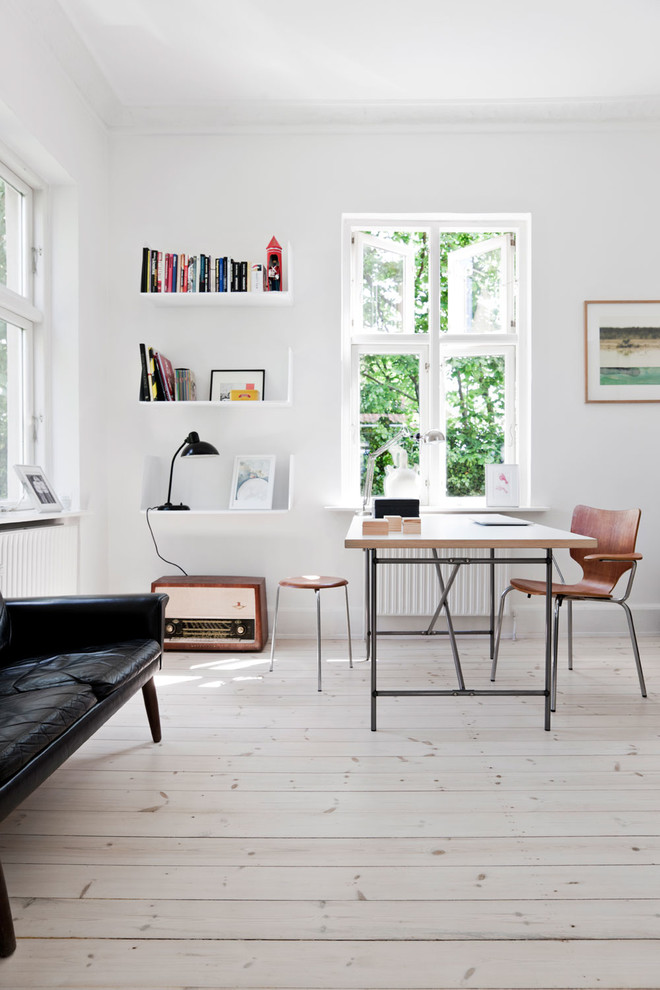 Mid-sized danish freestanding desk light wood floor home office photo in London with white walls
