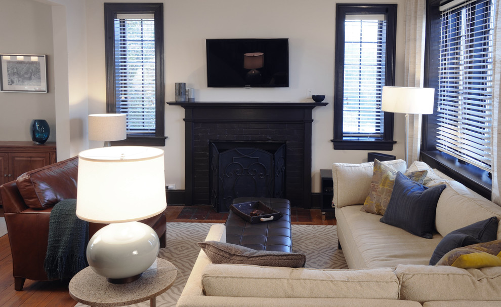 Inspiration for a mid-sized transitional formal open concept living room in DC Metro with beige walls, medium hardwood floors, a standard fireplace, a brick fireplace surround, a wall-mounted tv and brown floor.