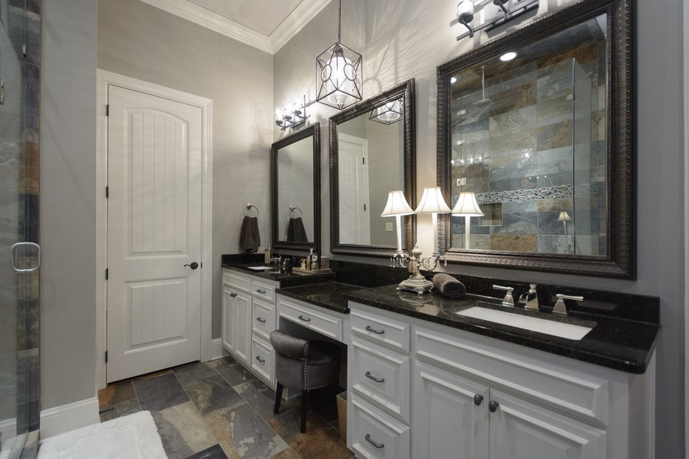 Photo of a large transitional master bathroom in New Orleans with raised-panel cabinets, white cabinets, an open shower, gray tile, slate, grey walls, slate floors, an undermount sink and granite benchtops.