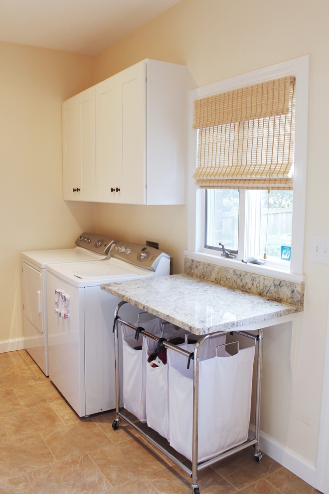 Inspiration for a mid-sized traditional galley utility room in Other with white cabinets, granite benchtops, beige walls, ceramic floors, a side-by-side washer and dryer, beige floor, beige benchtop and shaker cabinets.