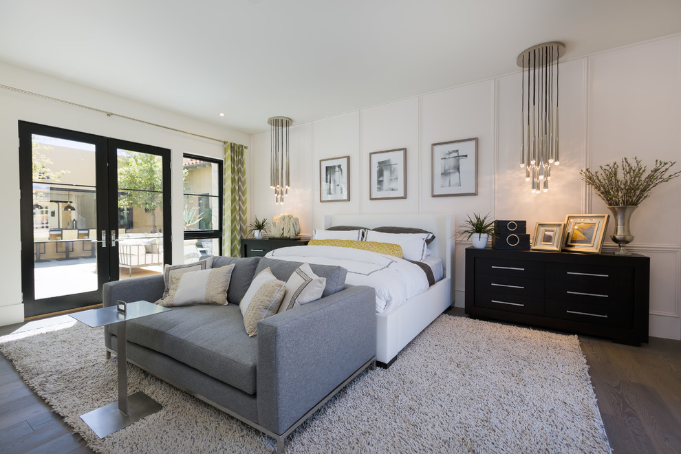 Large contemporary master bedroom in Phoenix with white walls, dark hardwood floors and brown floor.