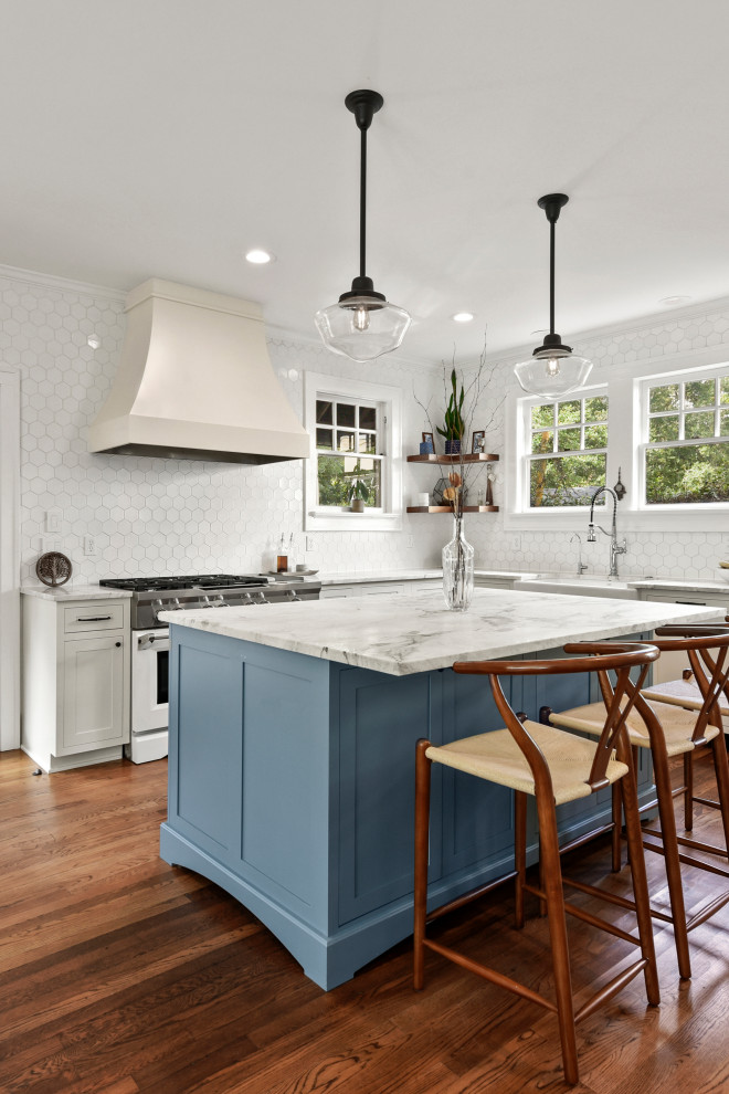 Eat-in kitchen - large transitional l-shaped medium tone wood floor and brown floor eat-in kitchen idea in Jacksonville with white backsplash, ceramic backsplash, stainless steel appliances and an island